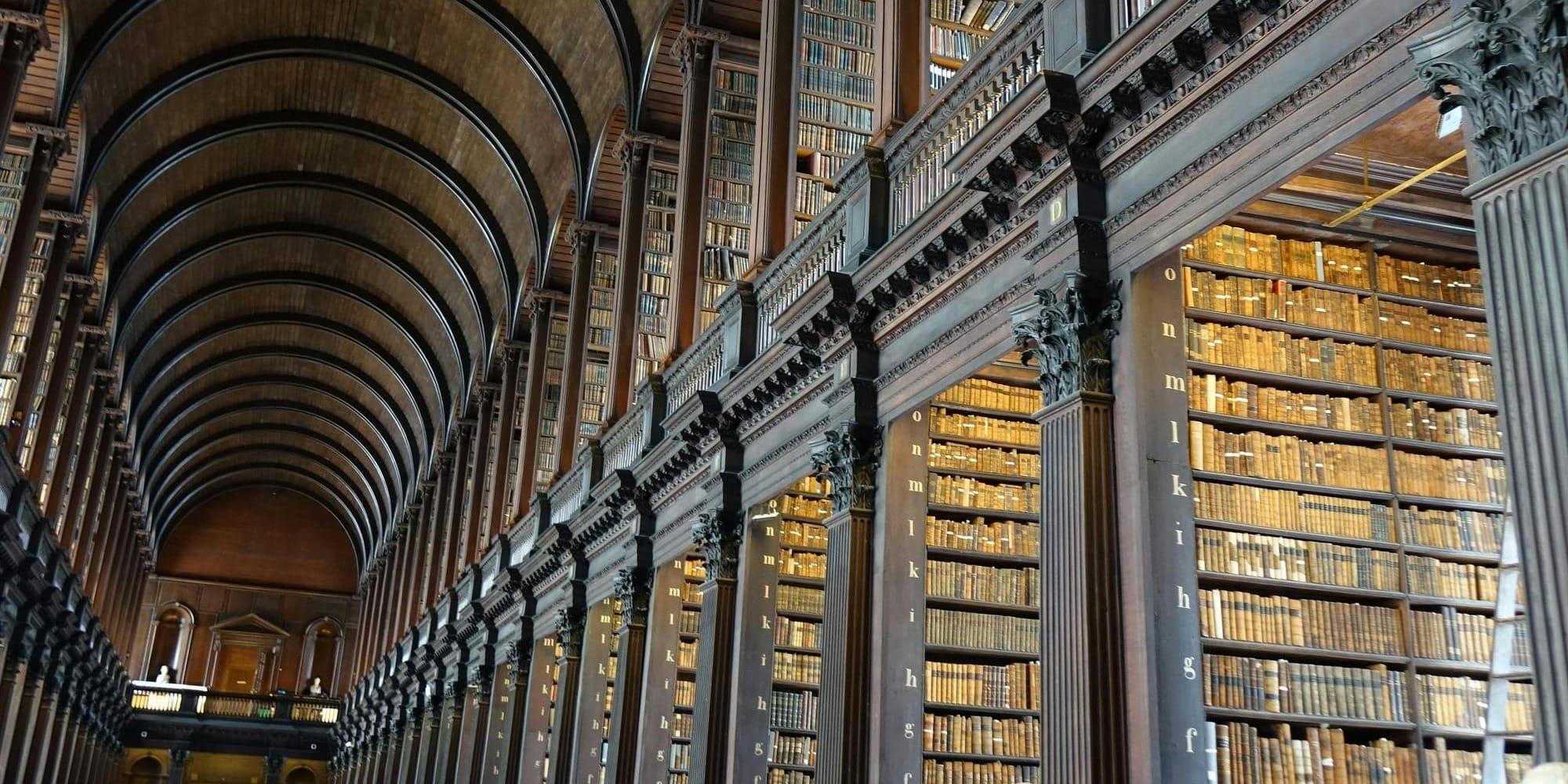 Interior of a historic library with towering bookshelves.