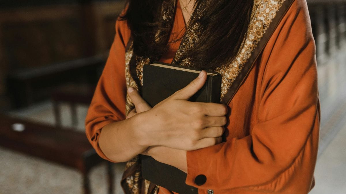 woman hugging a black book