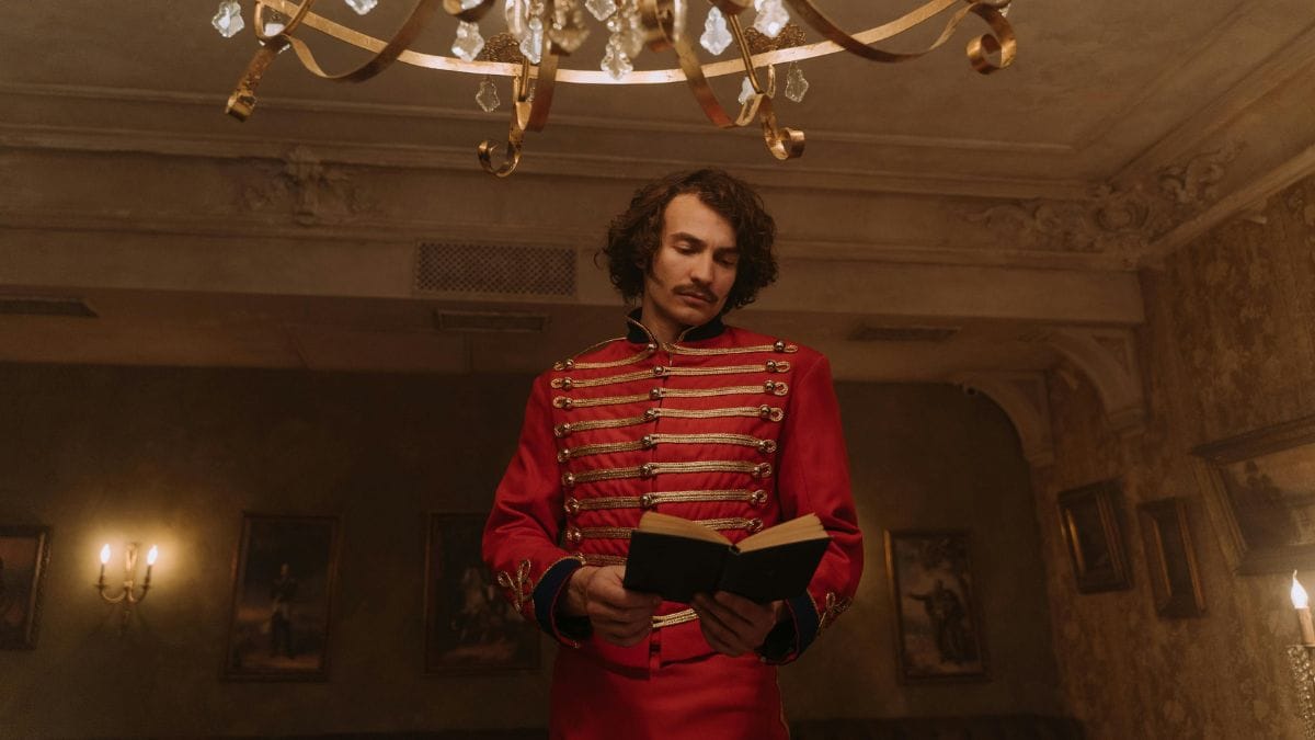a man in a historical uniform standing and reading a book