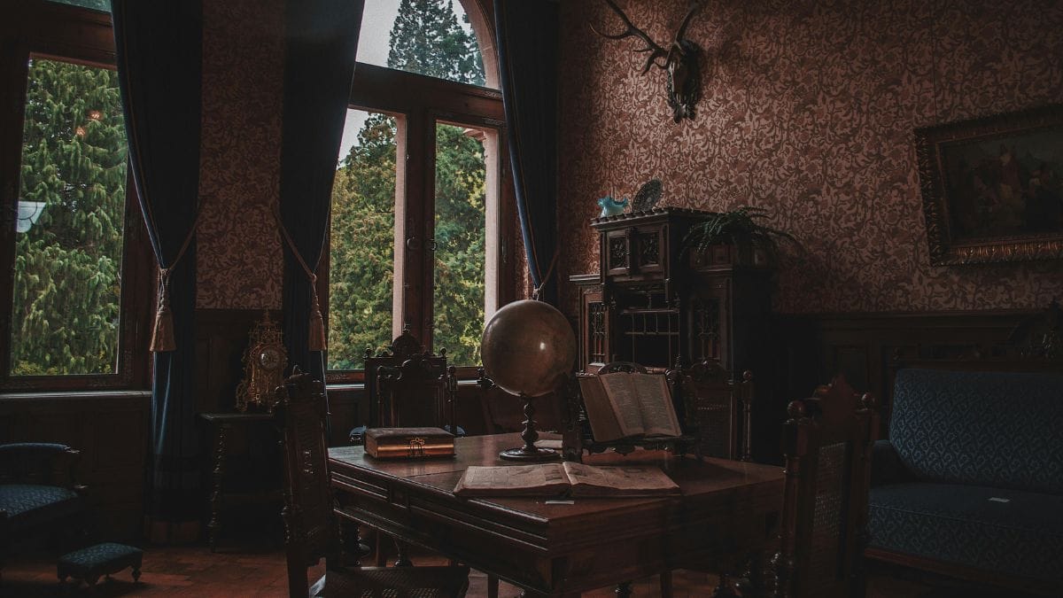 Vintage study room with globe, open books, and classic decor