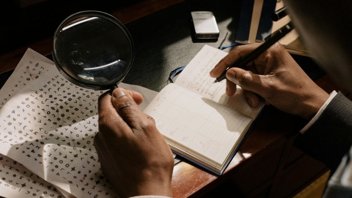 A magnifying glass and handwritten notes on a desk, evoking the atmosphere of classic detective fiction.